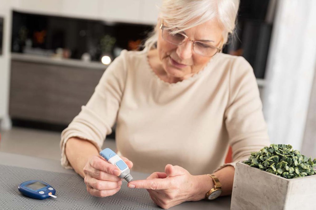 A woman pricks her finger to measure her insulin level